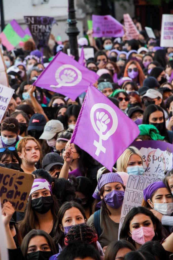 people holding purple and white banner