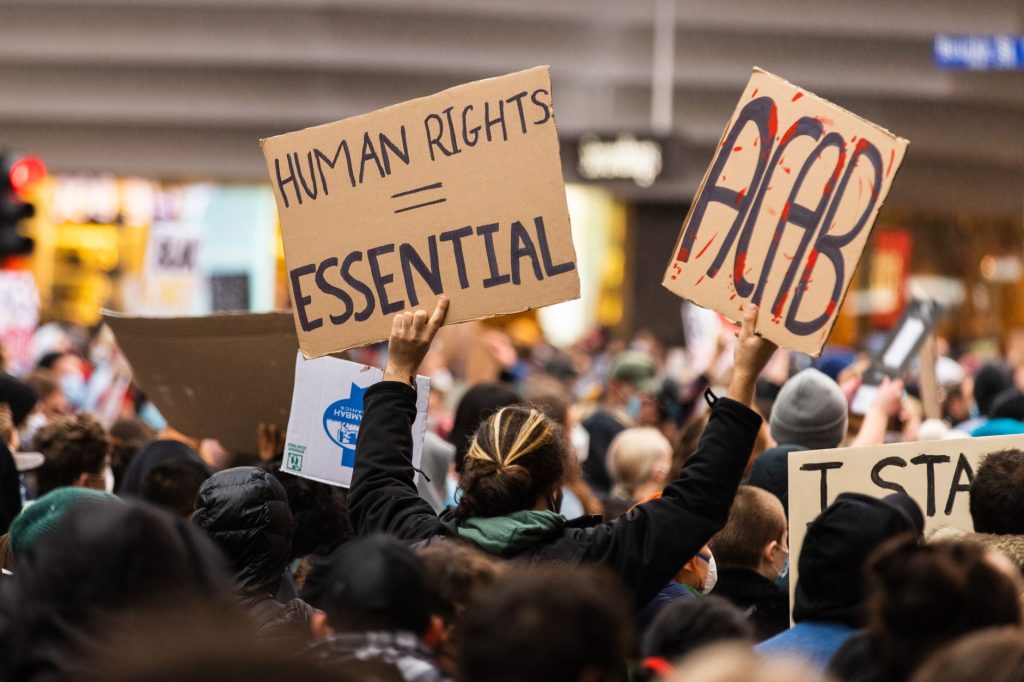 people holding cardboards with message