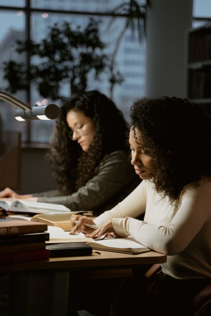women reading books in a library